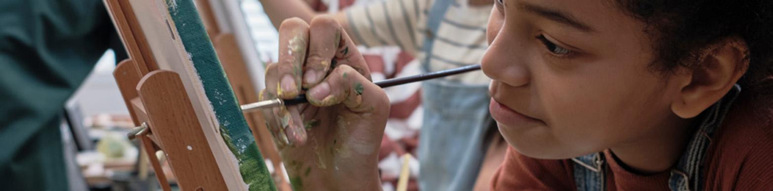 Image of a young african american girl painting